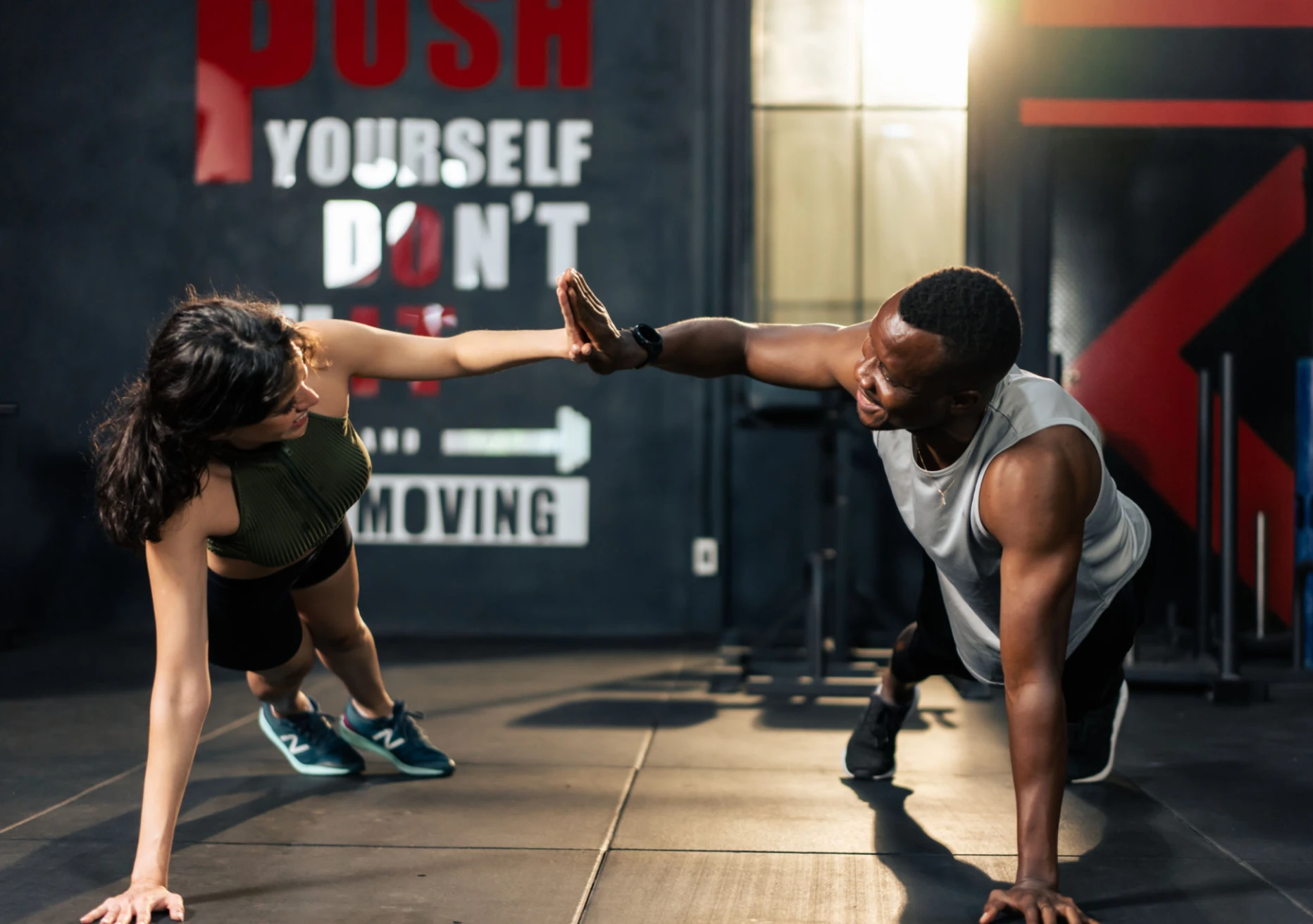 People high-fiving during a workout